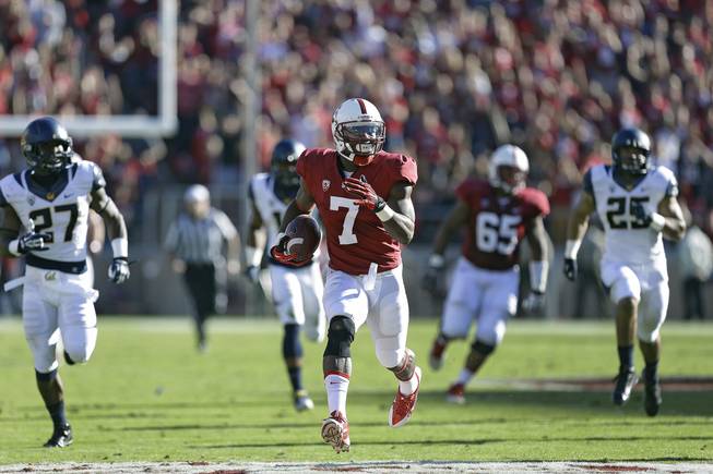Stanford wide receiver Ty Montgomery (7) runs for a touchdown against California defenders during the first half of an NCAA college football game in Stanford, Calif., Saturday, Nov. 23, 2013. 