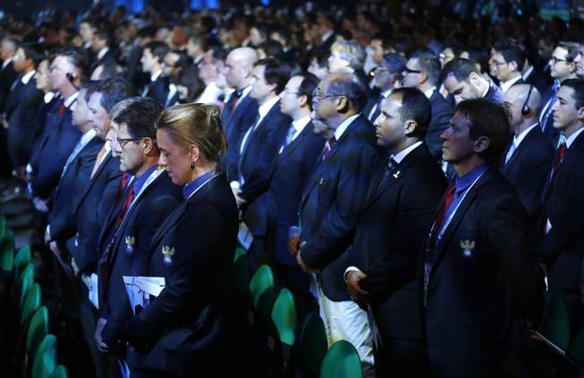 Delegates stand for a minute of silence for late South African President Nelson Mandela during the draw ceremony for the 2014 soccer World Cup in Costa do Sauipe near Salvador, Brazil, Friday, Dec. 6, 2013.