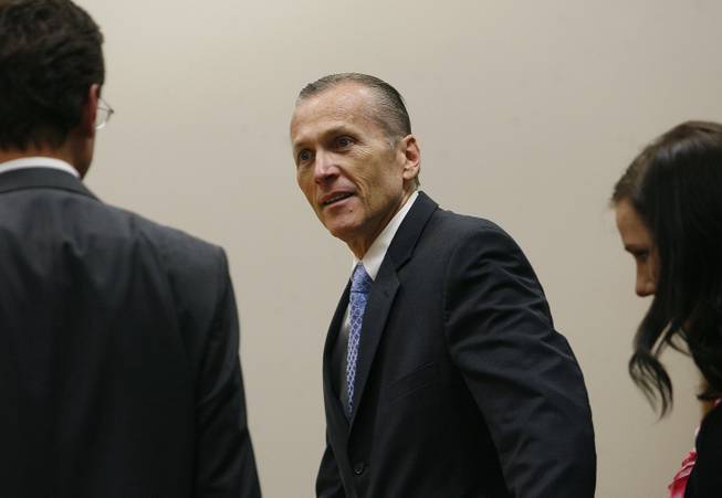 Martin MacNeill greets his defense team as he enters the courtroom after the jury reached a verdict. MacNeill was found guilty of murder and obstruction of justice early Saturday morning, Nov. 9, 2013.
