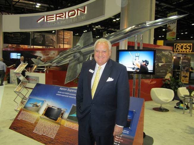 Brian Barents, vice chairman of Aerion Corp., at Aerion's exhibit at the National Business Aviation Association's convention in Orlando, Fla., earlier this month. Behind him is Aerion's design of a supersonic business jet. Molly McMillin/Wichita Eagle
