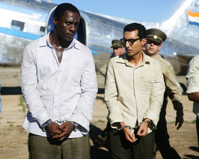 Idris Elba, left, as Nelson Mandela, and Riaad Moosa, as Ahmed Kathrada, appear in the film, "Mandela: Long Walk to Freedom."