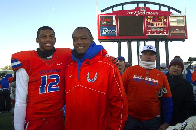 Bishop Gorman High School quarterback Randall Cunningham Jr. poses with his father after the team defeated Reed High School of Sparks, Nev. in the Division I state high school football championship game at Sam Boyd Stadium Saturday, Dec. 7, 2013.