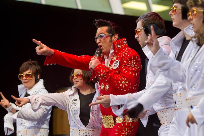 Elvis Presley impersonator Jesse Garon performs with the OV Elvi dance troupe during the annual Las Vegas Great Santa Run in downtown Las Vegas Saturday, Dec. 7, 2013. Officials said 11, 201 people participated in the event. Proceeds from the event benefit Opportunity Village, an organization that serves people with intellectual disabilities.