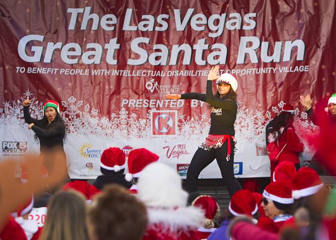 Zumba instructors leads runners in a workout before the annual Las Vegas Great Santa Run in downtown Las Vegas Saturday, Dec. 7, 2013. Officials said 11, 201 people participated in the event. Proceeds from the event benefit Opportunity Village, an organization that serves people with intellectual disabilities.