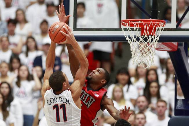 UNLV forward Roscoe Smith defends a shot by Arizona forward Aaron Gordon during the first half of their game at the McKale Center in Tucson Saturday, Dec. 7, 2013.