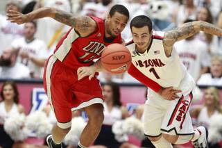UNLV guard Bryce Dejan Jones steals the ball from Arizona guard Gabe York during the first half of their game at the McKale Center in Tucson Saturday, Dec. 7, 2013.
