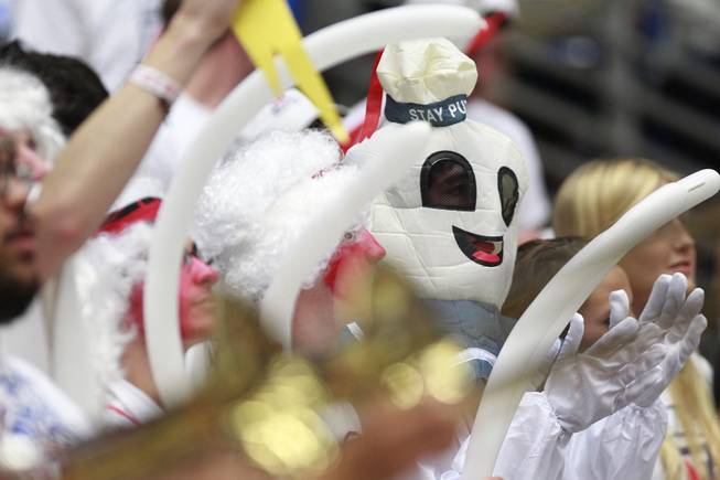 An Arizona fan dressed as the Stay Puft Marshmallow Man cheers on the Wildcats against UNLV during their game at the McKale Center in Tucson Saturday, Dec. 7, 2013. Arizona won the game 63-58.