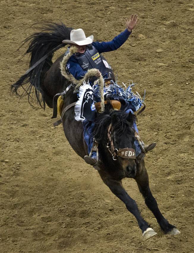 Saddle bronc rider Jesse Wright keeps great form during the Wrangler National Finals Rodeo Go-Round Day 3 at the Thomas & Mack Center in Las Vegas, Nevada, on Saturday,  Dec. 7, 2013.
