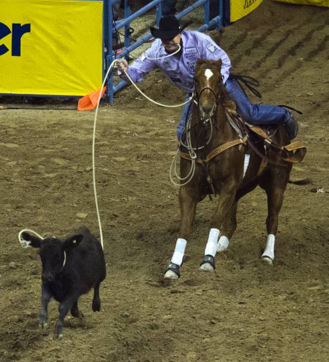 Tie-down roper Cody Ohl readies to rope a calf during the Wrangler National Finals Rodeo Go-Round Day 3 at the Thomas & Mack Center in Las Vegas, Nevada, on Saturday,  Dec. 7, 2013.