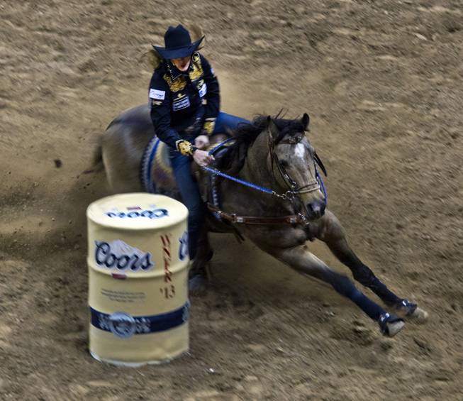 Barrel racer Taylor Jacob turns a corner during the Wrangler National Finals Rodeo Go-Round Day 3 at the Thomas & Mack Center in Las Vegas, Nevada, on Saturday,  Dec. 7, 2013.