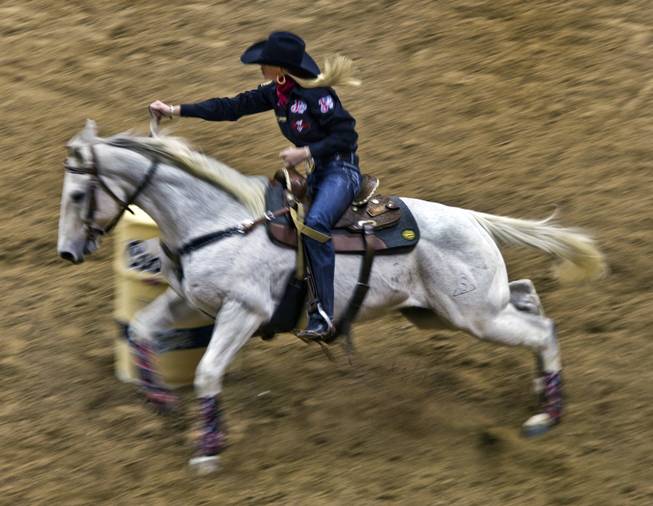 Barrel racer Kaley Bass navigates a turn during the Wrangler National Finals Rodeo Go-Round Day 3 at the Thomas & Mack Center in Las Vegas, Nevada, on Saturday,  Dec. 7, 2013.