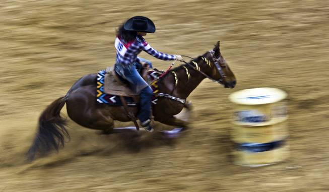 Barrel racer Christy Loflin approaches a turn during the Wrangler National Finals Rodeo Go-Round Day 3 at the Thomas & Mack Center in Las Vegas, Nevada, on Saturday,  Dec. 7, 2013.