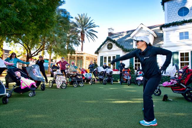 Owner and instructor Jessica Peralta runs through a series of warm-up exercises with moms and their babies during the Stoller Strides class, a program offered by FIT4MOM Las Vegas, at Town Square Mall in Las Vegas Friday morning, December 6, 2013.