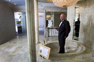 British businessman Martyn J. Ravenhill poses in a marble bath tub during an open house and book signing at the Liberace house Monday, Dec. 9, 2013. Ravenhill purchased Liberace's former residence for $500,000 in August. He also recently published a book titled 