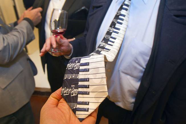 Former Lt. Gov. Lonnie Hammargren sports a piano-themed necktie during an open house and book signing at the Liberace house Monday, Dec. 9, 2013.  Liberace's former residence was purchased by British businessman Martyn J. Ravenhill for $500,000 in August.