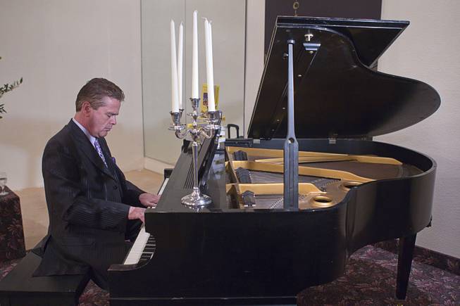 Pianist Greg Bowers performs during an open house and book signing at the Liberace house Monday, Dec. 9, 2013.  Liberace's former residence was purchased by British businessman Martyn J. Ravenhill for $500,000 in August.