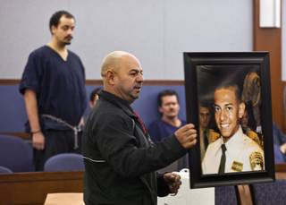 Ernesto Velasquez holds a picture of his son Angel as he addresses the court during sentencing for Jvon Williams on Monday,  Dec. 9, 2013.