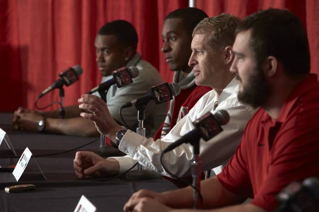 UNLV coach Bobby Hauck, second from right, and players (from left) Kenneth Penny, Caleb Herring and Brett Boyko answer questions about the Heart of Dallas Bowl at the Rebels' press conference on Monday, Dec. 9, 2013.