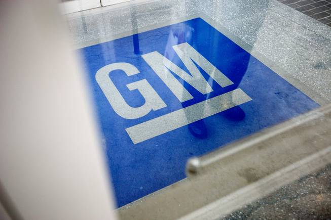 In this Thursday, Jan. 10, 2013, file photo, the logo for General Motors decorates the entrance to a former UPS facility as GM announced plans to open an information technology center in the building, in Roswell, Ga. 