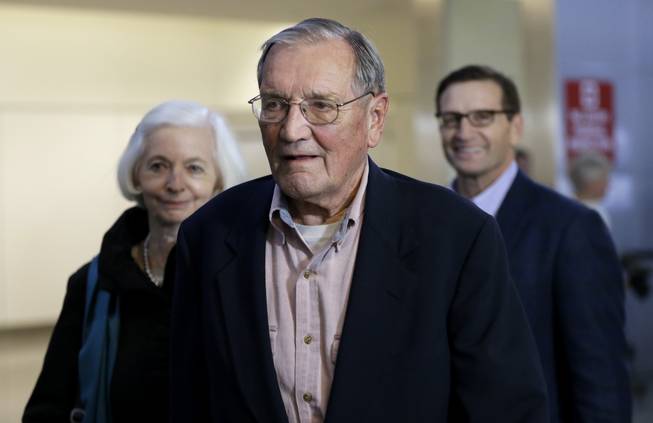 Merrill Newman, center, walks beside his wife Lee, left, and his son Jeffrey after arriving at San Francisco International Airport on Saturday, Dec. 7, 2013. Newman was detained in North Korea late October at the end of a 10-day trip to North Korea, a visit that came six decades after he oversaw a group of South Korean wartime guerrillas during the 1950-53 war. He was released from North Korea early Saturday.