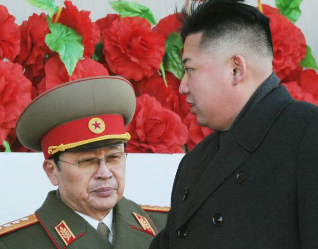 In this Feb. 16, 2012, photo, North Korean leader Kim Jong Un walks past his uncle Jang Song Thaek, left, after reviewing a parade of thousands of soldiers and commemorating the 70th birthday of the late Kim Jong Il in Pyongyang, North Korea.
