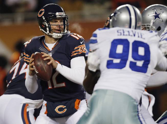 Chicago Bears quarterback Josh McCown (12) looks to pass the ball during the first half of an NFL game against the Dallas Cowboys on Monday, Dec. 9, 2013, in Chicago. 