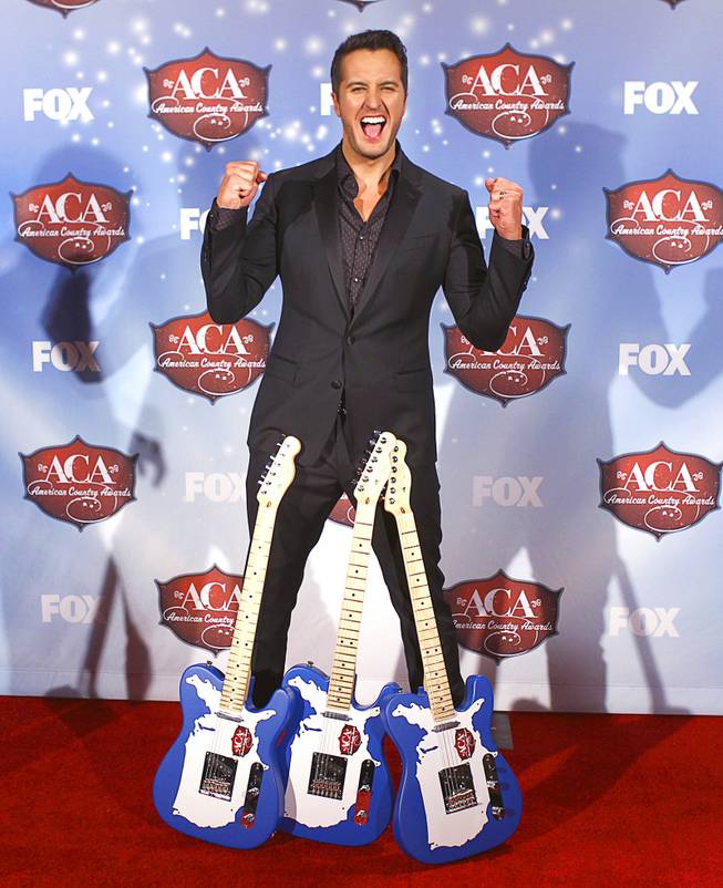 Luke Bryan stands with his awards during the 4th annual American Country Awards at Mandalay Bay Events Center on Tuesday, Dec. 9, 2013. Bryan won three awards, including Artist of the Year.