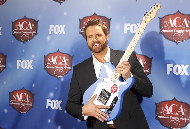 Randy Houser stands with the award for Most Played Radio Track at the 4th annual American Country Awards at Mandalay Bay Events Center on Tuesday, Dec. 9, 2013.