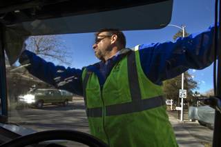 Jerry Bates starts his route with clean windows as a driver with the Republic Services recycling truck on Tuesday, Dec. 10, 2013.  L.E. Baskow