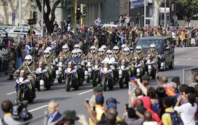 The procession for former South African president Nelson Mandela makes its way through the streets of Pretoria, South Africa, Wednesday, Dec. 11, 2013. 
