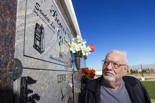 Frank Bower looks at a marker for his wife on an ashes wall at Palm Boulder Highway Mortuary & Cemetery in Henderson Wednesday, Dec. 11, 2013. After his wife Sandra Lee died in 2011, he had a portion of her ashes sent into space.