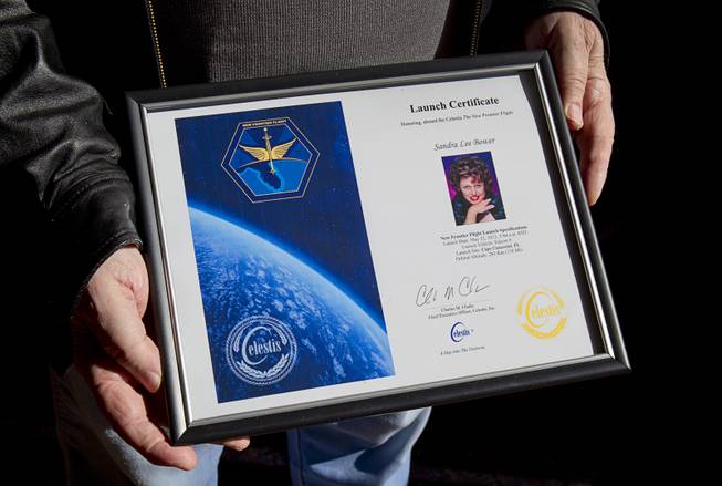 Frank Bower holds a launch certificate from Celestis at Palm Boulder Highway Mortuary & Cemetery in Henderson Wednesday, Dec. 11, 2013. After his wife Sandra Lee died in 2011, he had a portion of her ashes sent into space.