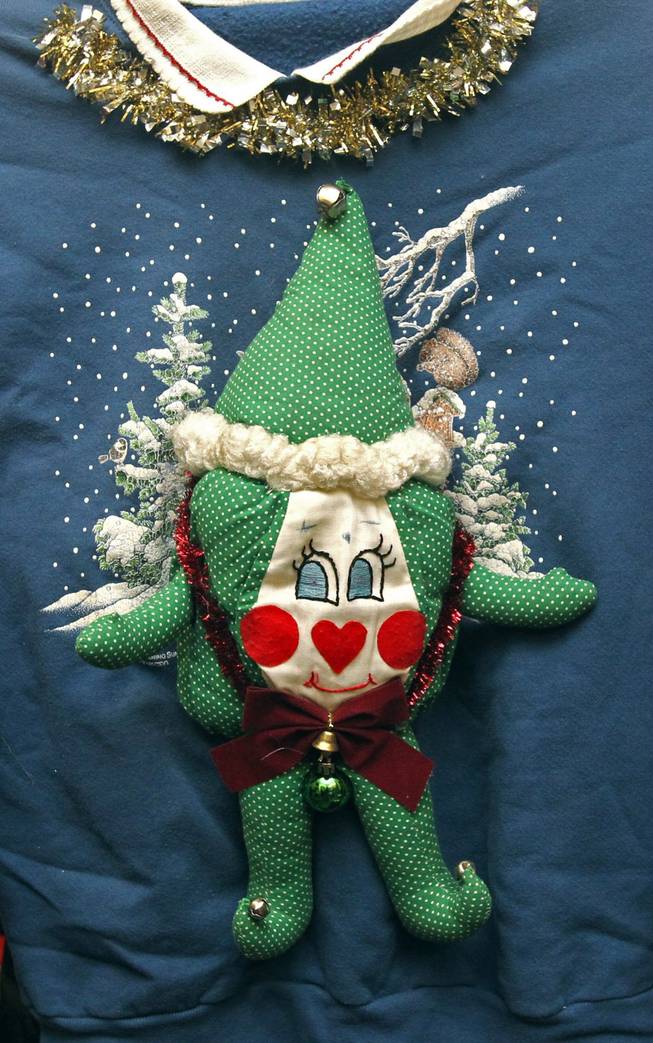 A detailed view of one of the uglier Christmas sweaters that is part of the stash of owner Troy Zulich, taken at his warehouse, Dec. 11, 2013, in Akron, Ohio. Ugly Christmas sweaters and vests have become a staple for guests at holiday parties to wear.