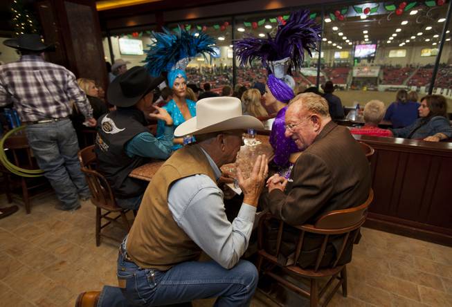 Former Las Vegas mayor Oscar Goodman (right) chats with one of many rodeo fans in the bar during the XIII World Series of Team Roping (WSTR) Finals at the South Point Hotel Wednesday, Dec. 11, 2013.