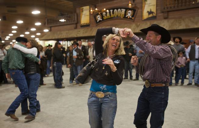 Couples dance to the music of Daryle Singletary following the XIII World Series of Team Roping (WSTR) Finals at the South Point Hotel Wednesday, Dec. 11, 2013.