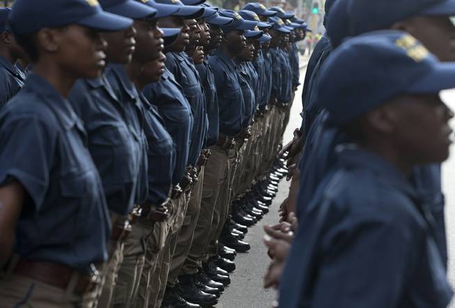 South African police stand in line outside the Union Buildings grounds in Pretoria, South Africa, Wednesday Dec. 11, 2013 where the body of Nelson Mandela lies in state for three days. 