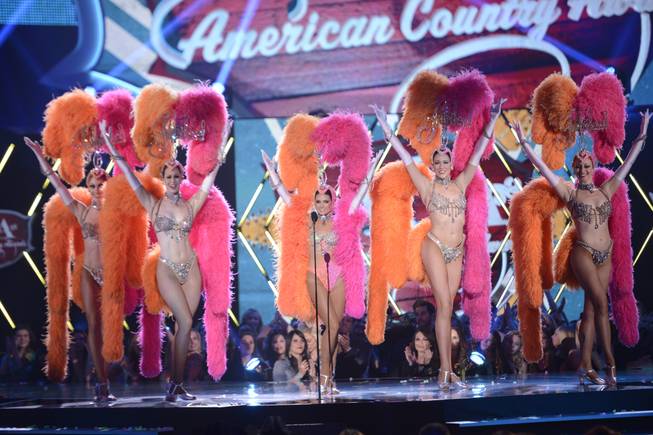 Co-host Danica Patrick appears onstage with dancers from "Jubilee!" at Bally's during the 2013 American Country Awards on Tuesday, Dec. 10, 2013, at Mandalay Bay Events Center in Las Vegas.