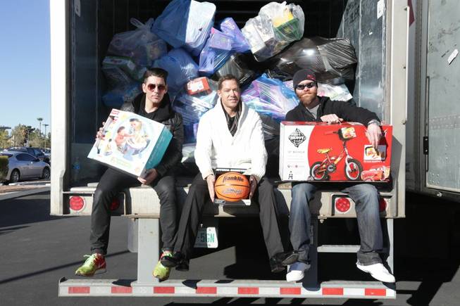 Ronn Nicolli, Jesse Waits and John Wood take part in the 2013 XS and Tryst holiday toy drive on Thursday, Dec. 12, 2013, in Las Vegas.
