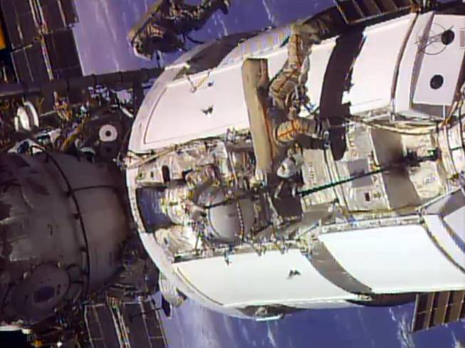 In this frame grab from video provided by NASA, two Russian flight engineers perform maintenance on the International Space Station, Monday, June 24, 2013. NASA said Dec. 11, 2013, it is looking into a problem with a malfunctioning cooling pump on the International Space Station, but there is no immediate danger to the six crewmen on board. Agency spokesman Kelly Humphries says the problem may eventually be serious, but is not an emergency at the moment.