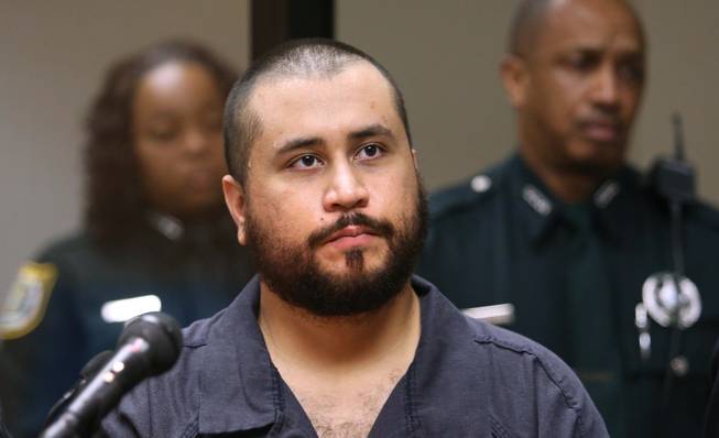  In this Tuesday, Nov. 19, 2013, file photo, George Zimmerman, acquitted in the high-profile killing of unarmed black teenager Trayvon Martin, listens in court, in Sanford, Fla., during his hearing on charges including aggravated assault stemming from a fight with his girlfriend. Prosecutors announced Wednesday, Dec. 11, 2013, that they will not file domestic violence charges against Zimmerman.