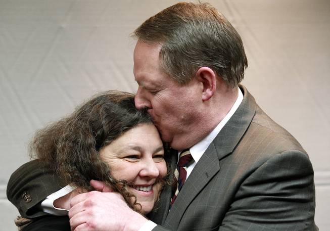 David Warren embraces his wife, Kathy, during a news conference in Metairie, La., Wednesday, Dec. 11, 2013. A federal jury found former New Orleans police officer David Warren not guilty on manslaughter charges in the shooting death of Henry Glover, 31, whose body was found burned in a car, in the aftermath of Hurricane Katrina. 