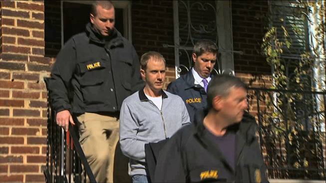 This image from video provided by WJLA-TV shows Ryan Loskarn, chief of staff to Sen. Lamar Alexander, R-Tenn., being escorted from his Washington home by U.S. Postal Inspector police on Wednesday, Dec. 11, 2013.