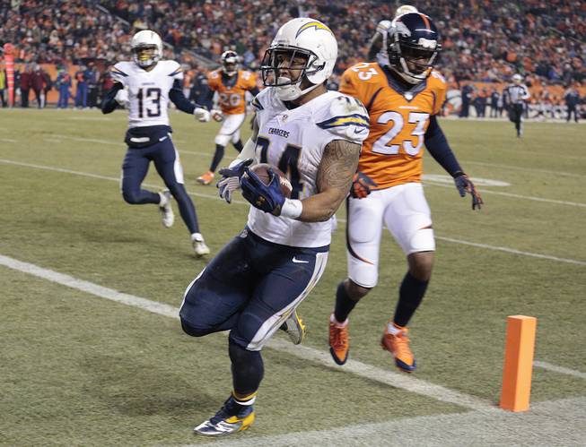 San Diego Chargers running back Ryan Mathews (24) crosses the goal line ahead of Denver Broncos cornerback Quentin Jammer (23) for a touchdown in the third quarter Thursday, Dec. 12, 2013, in Denver. 