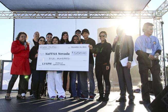 Organizers receive a $500 donation during "LV4PH," a festival relief effort to aid the victims of Typhoon Yolanda, held at Rio All-Suites Hotel & Casino on Saturday, Dec. 14, 2013.