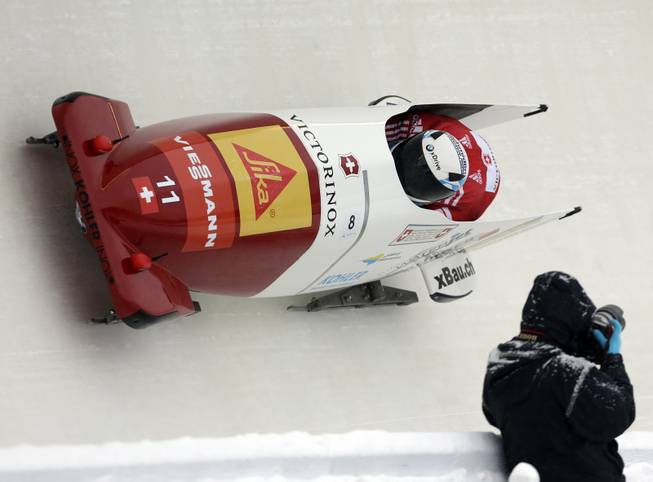 Switzerland's pilot Beat Hefti and brakeman Alex Baumann compete in the first heat of the two-man bobsled World Cup event on Friday, Dec. 13, 2013, in Lake Placid, N.Y. 