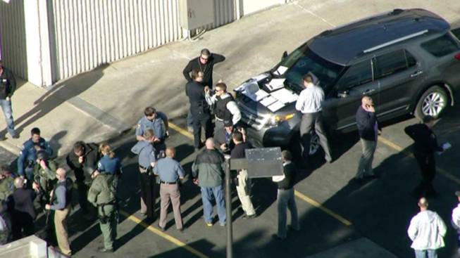 In this still image taken from video provided by Fox 31 Denver, police respond to reports of a shooting at Arapahoe High School in Centennial, Colo. Friday, Dec. 13, 2013.