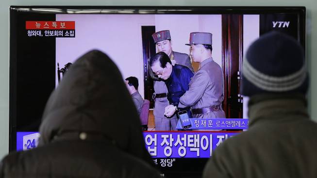 In this Dec. 12, 2013, file photo, people watch a TV news report about the execution of Jang Song Thaek, the uncle of North Korean leader Kim Jong Un, at Seoul Railway Station in Seoul, South Korea. The letters on the left top, read "North Korea Executed Jang Song Thaek after trial." The stunning execution of Kim Jong Un's powerful uncle strips China of its most important link to North Korea's leadership and deepens concerns over how the unruly neighbor will proceed on Beijing's key issues of nuclear disarmament and economic reform.
