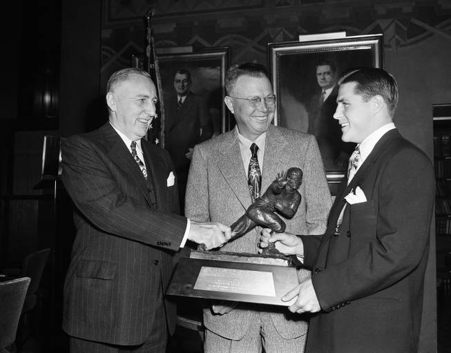 Doak Walker, a star player for Southern Methodist, looks over Heisman Memorial Trophy in New York on Dec. 7, 1948. Picked as the nation's outstanding college football player by sportswriters and broadcasters, Walker formally was presented with the award later in the day at a dinner in the Downtown Athletic Club.