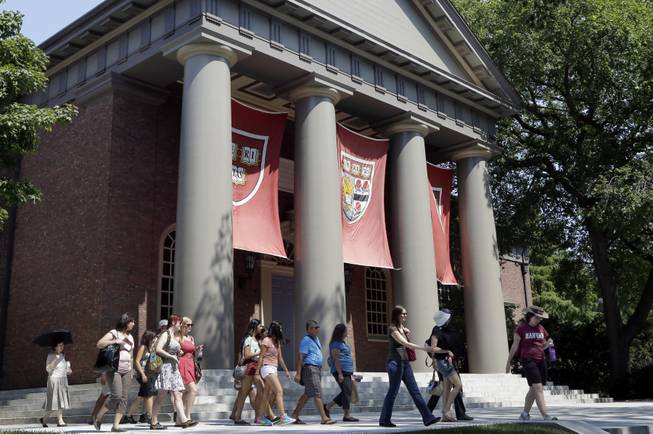 In this Aug. 30, 2012, file photo, people are led on a tour of Harvard University in Cambridge, Mass.