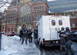 SWAT team officers arrive at a building at Harvard University in Cambridge, Mass., Monday, Dec. 16, 2013. 